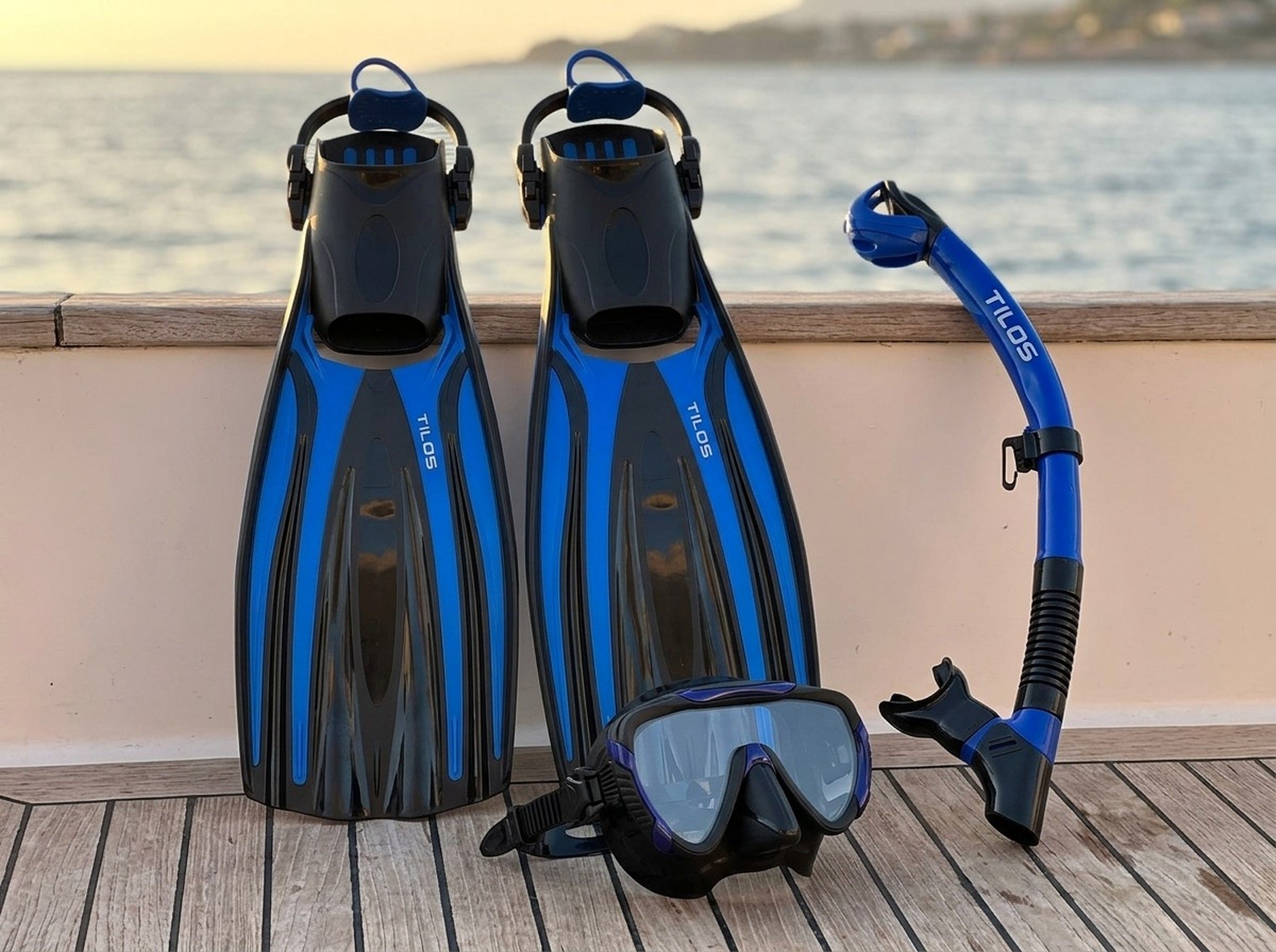Snorkeler using the Tilos Morphi Mask, Orion Snorkel and Forager Fins Set in Black/Blue — sunset deck