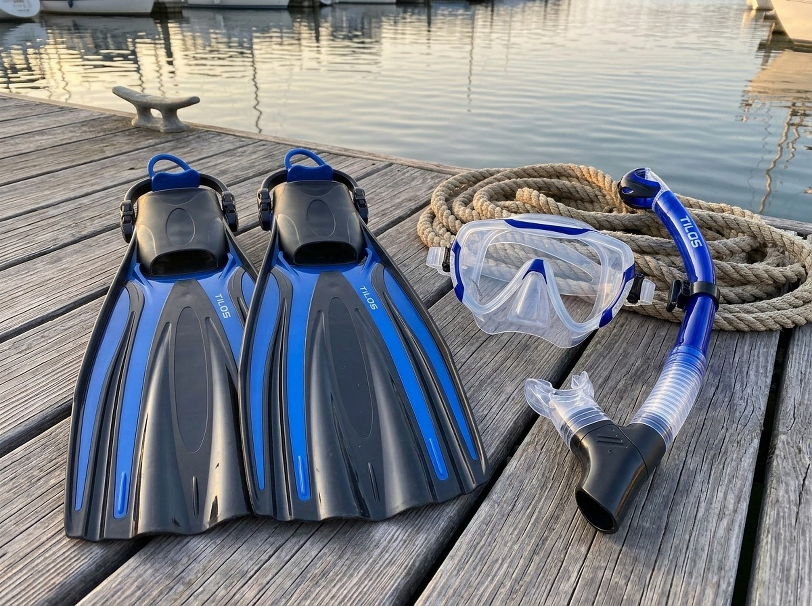 Snorkeler using the Tilos Morphi Mask, Orion Snorkel and Forager Fins Set in Blue — marina dock