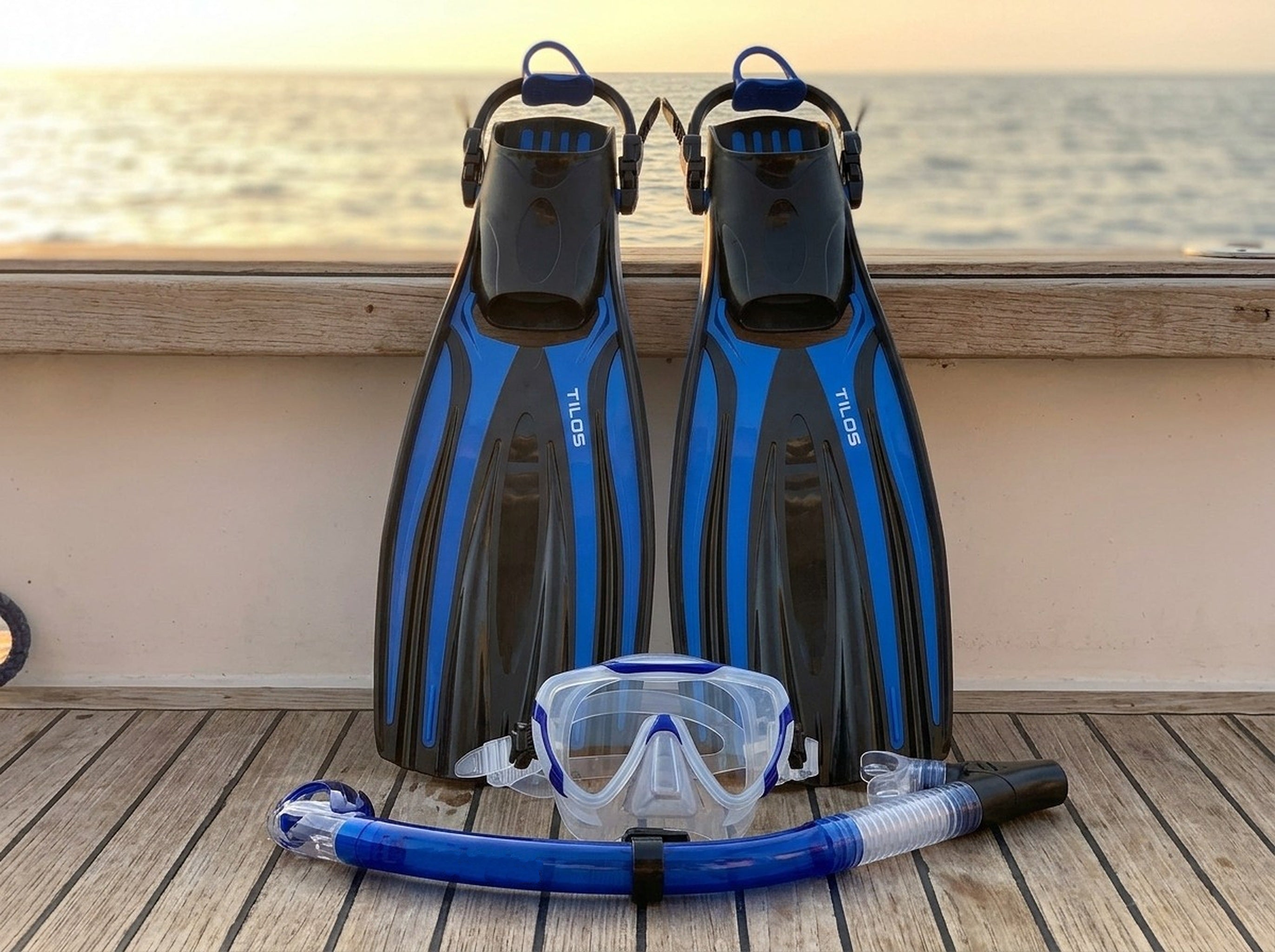 Snorkeler using the Tilos Morphi Mask, Orion Snorkel and Forager Fins Set in Blue — sunset deck